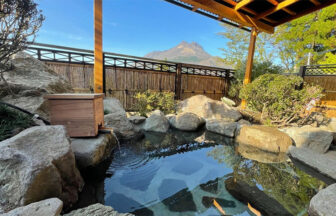 大分県湯布院の犬と泊まれる宿「由布院 吾亦紅（われもこう）」の露天風呂。岩造りの湯船の向こうに、新緑に映える由布岳の絶景が広がる様子