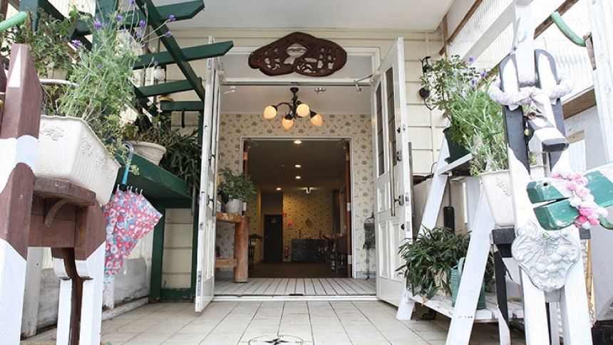 白を基調としたカントリー調のインテリアや植物が並ぶ、玉原高原「ペンション グリーンウッド」の開放的なエントランス（正面玄関）